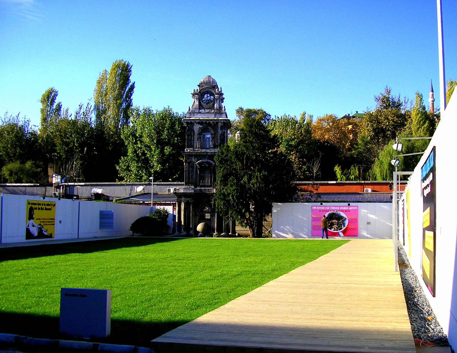 a grassy yard next to a building with trees