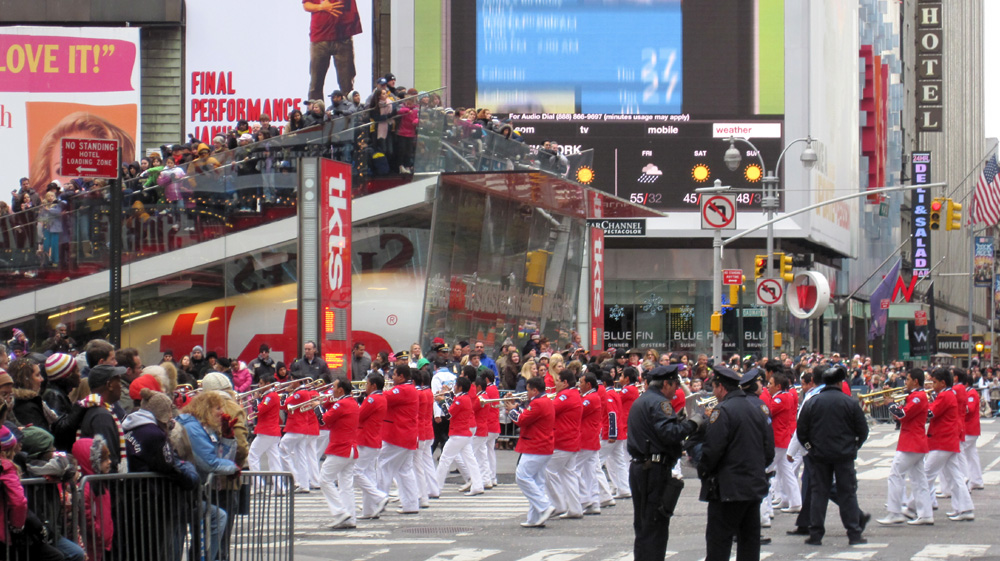 several people in red and white outfits standing on the street