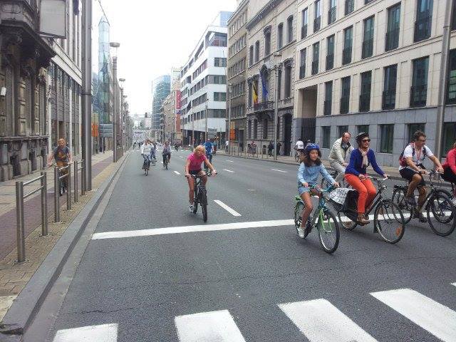 the people are riding bicycles on the road