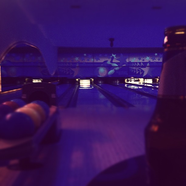 bowling alley with glowing lanes and bowling pins