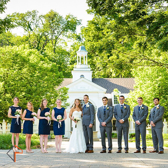 bride and grooms standing outside for a po