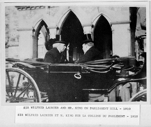 two men in a horse - drawn carriage in front of a building