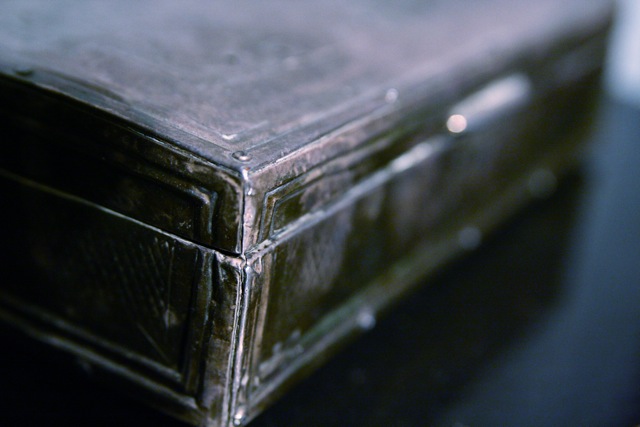 a closeup view of a dark, leather, and stained case