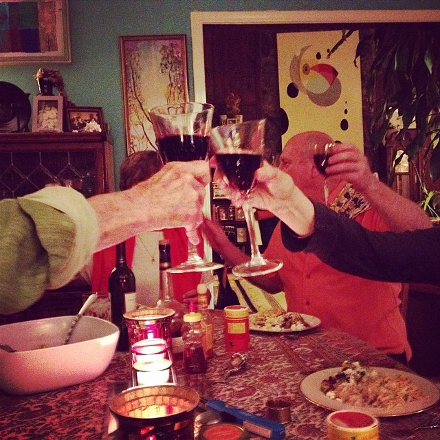 a group of people toasting with wine glasses