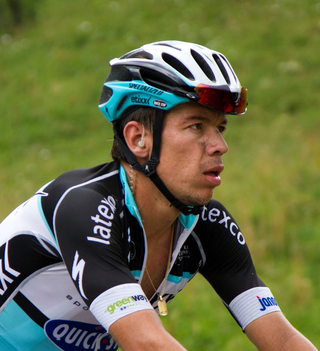 man riding a bicycle wearing a helmet and helmet