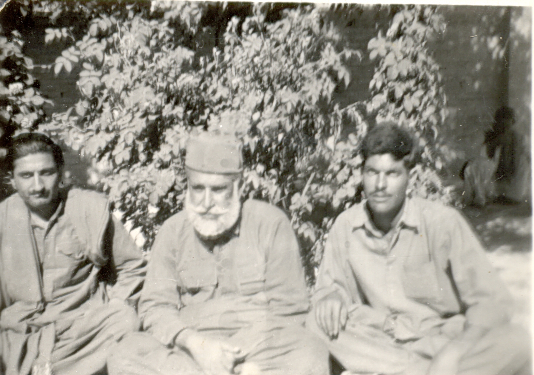 three men in uniforms sitting next to each other