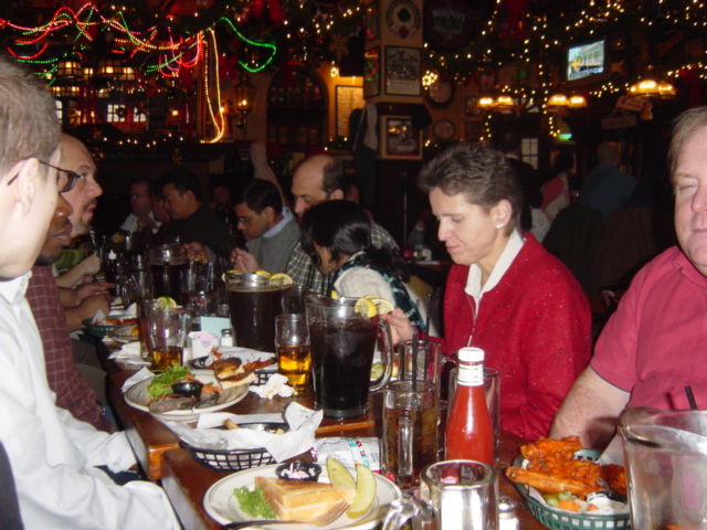 four people are sitting at the table in front of food