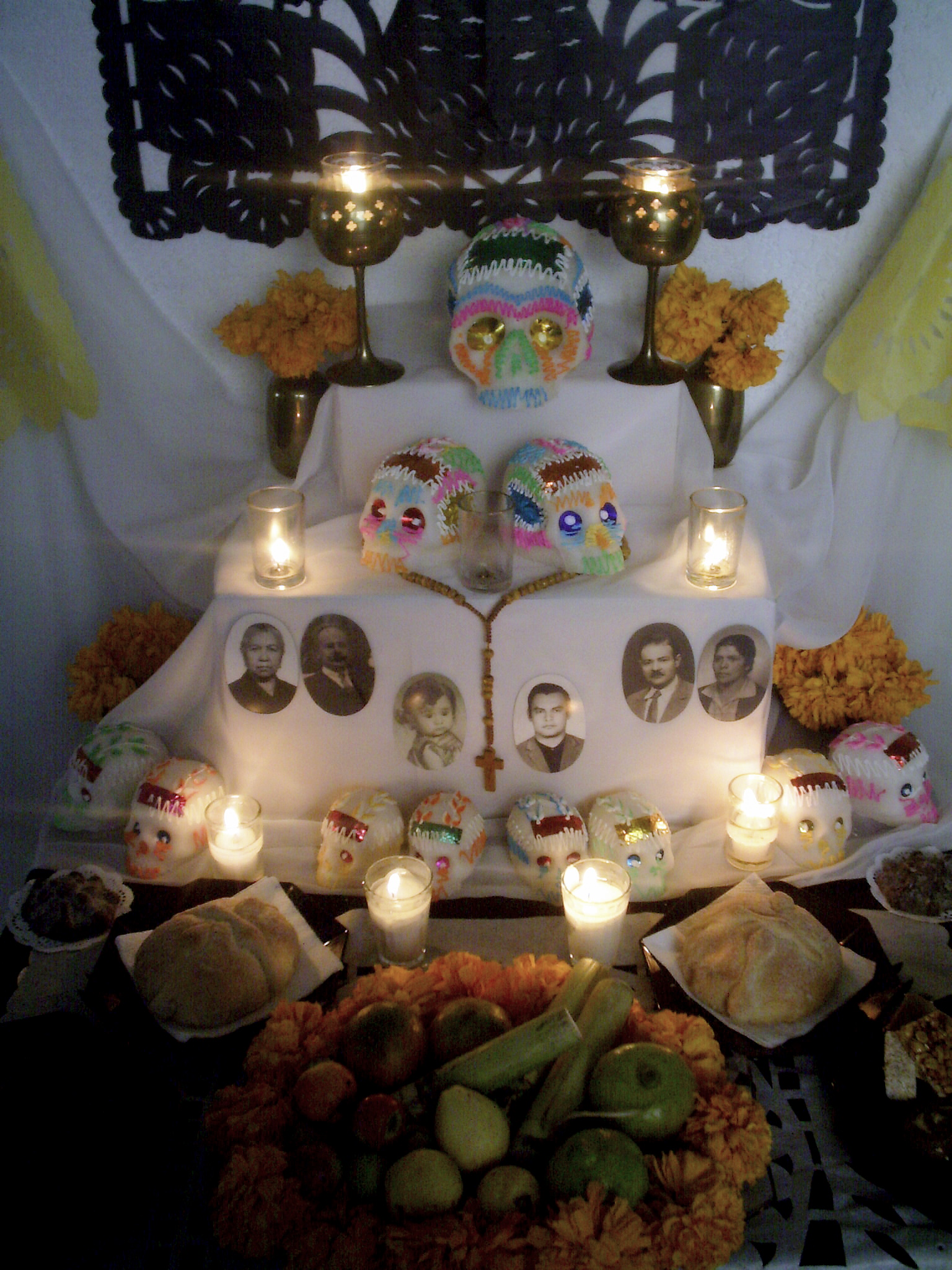 a dessert display with candles and a wall hanging