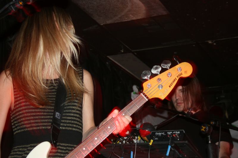 two women playing music in a dark room