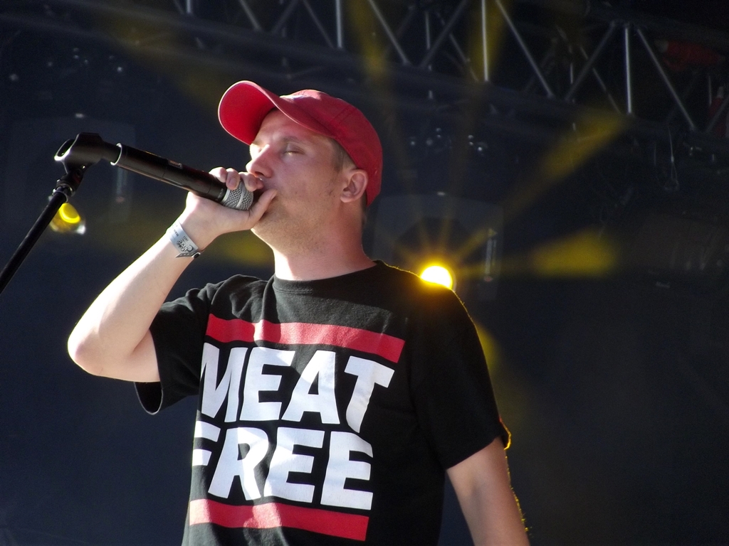 a man in red hat holding a microphone in front of him