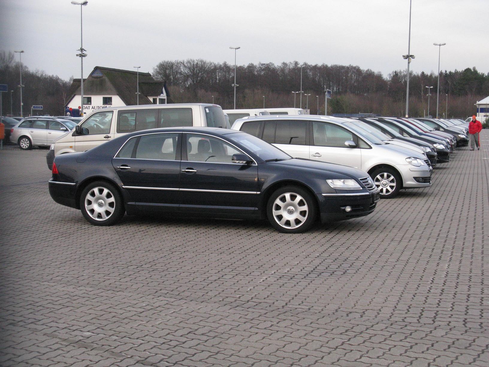 several cars lined up next to each other on a brick lot