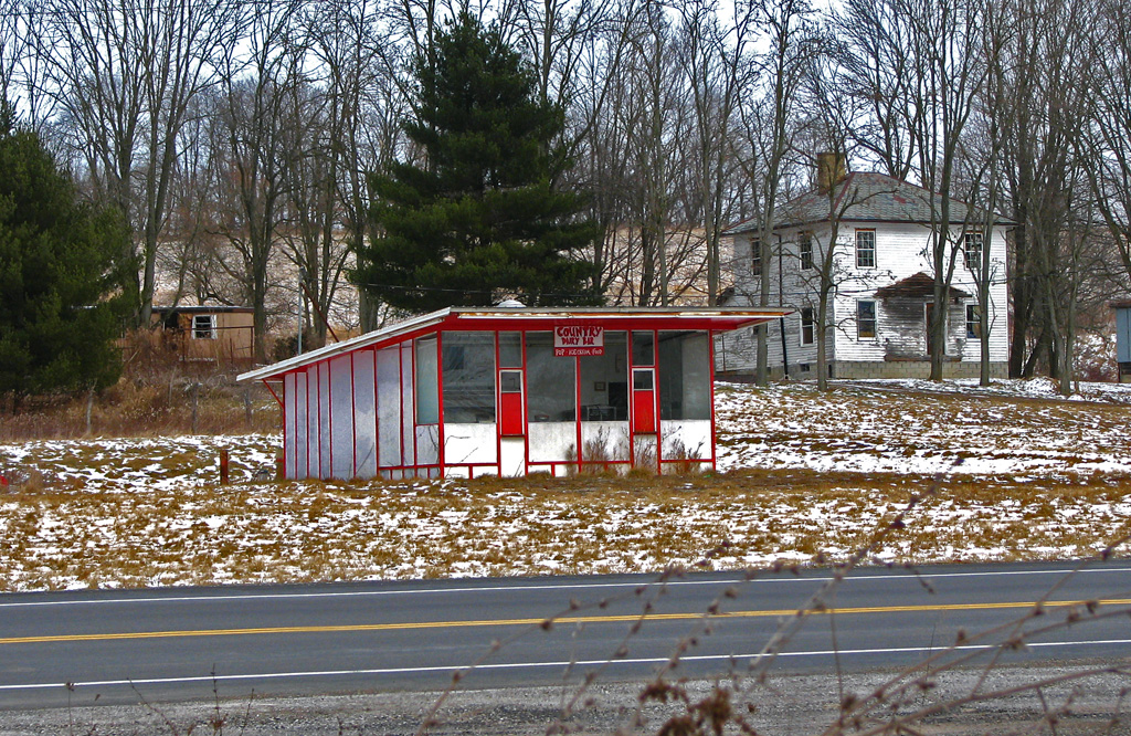 the red cabin is set up on the side of the road