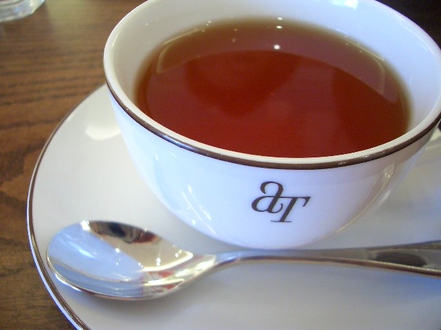 a cup of tea with a spoon on a plate