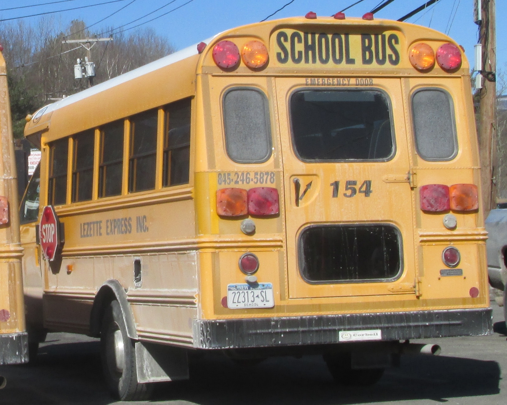 two yellow school buses driving down the road