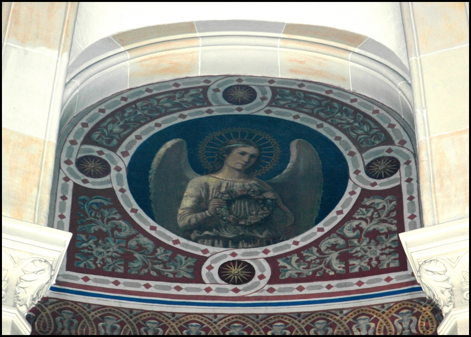 the angel is holding a dove above it