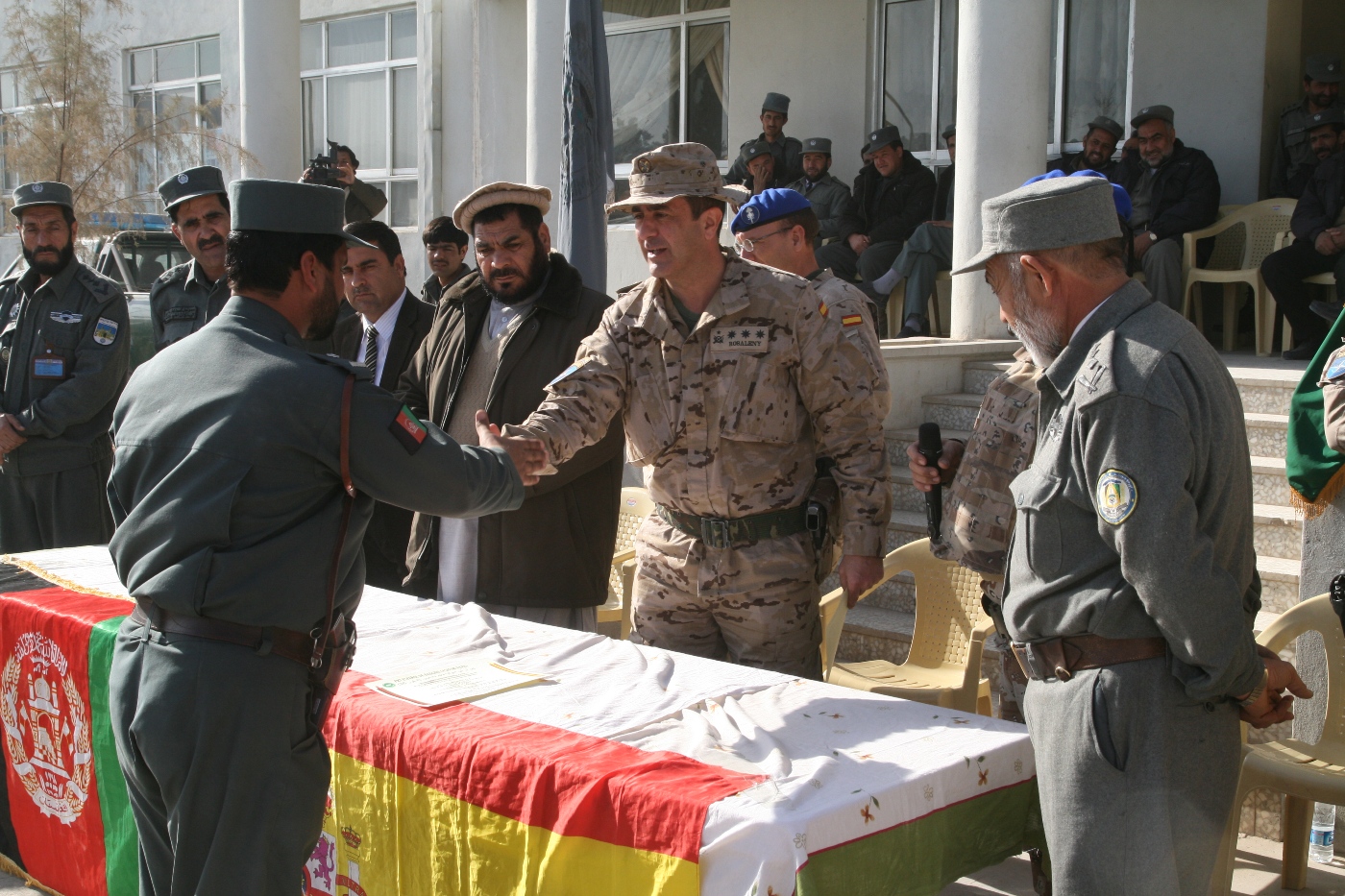 some men are shaking hands in front of an american flag