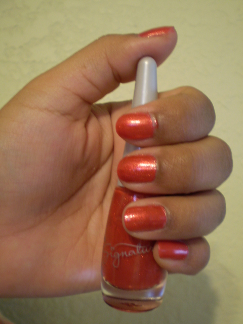a woman's hand holding onto a red manicure
