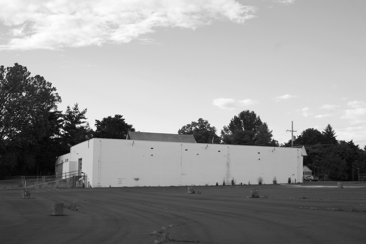 black and white po of an industrial building and field