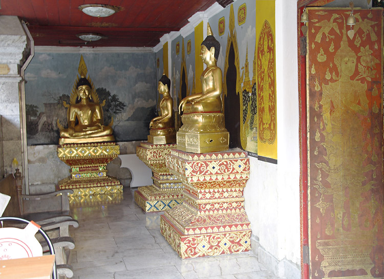 a number of gold statues inside of a building