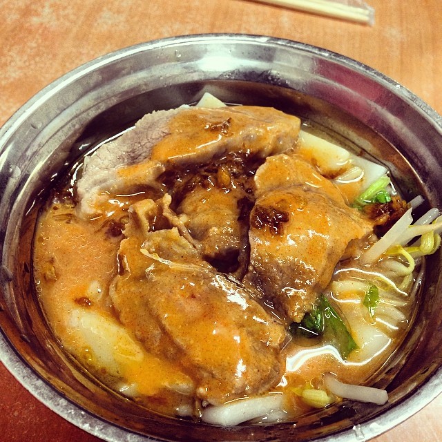 a bowl full of meat with noodle in a broth