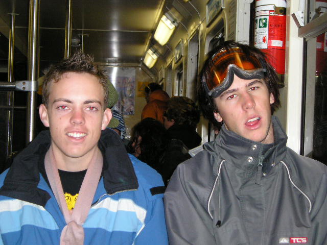 two guys on a bus wearing ski gear