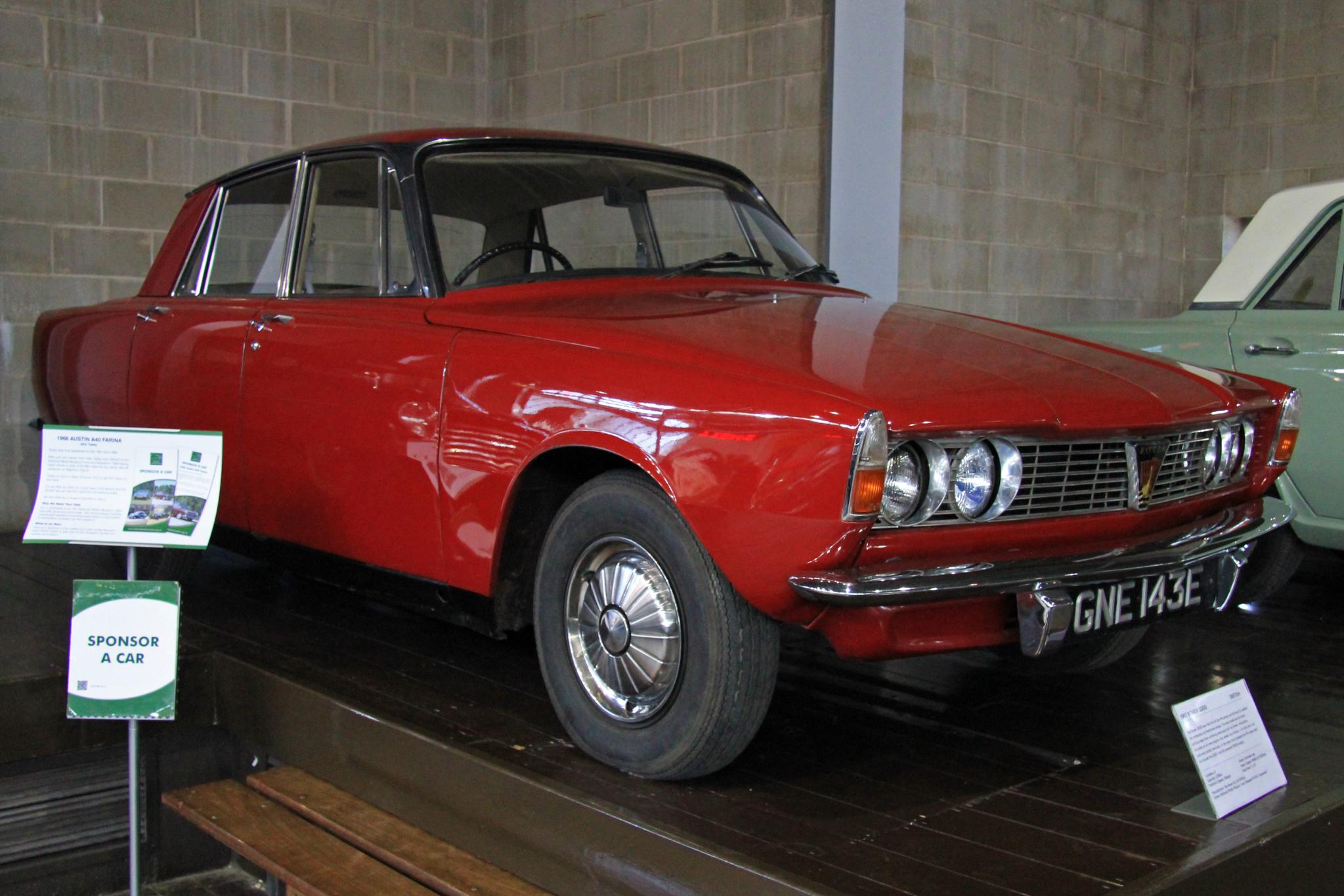 a classic car sitting on display with other cars