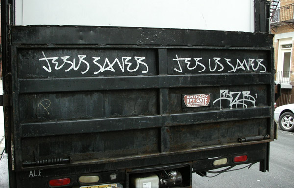 some writing on the back of a dumpster