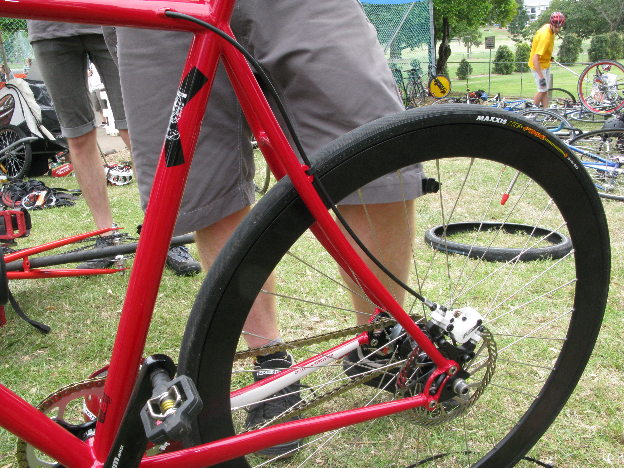 a close up of a person's feet on a red bike