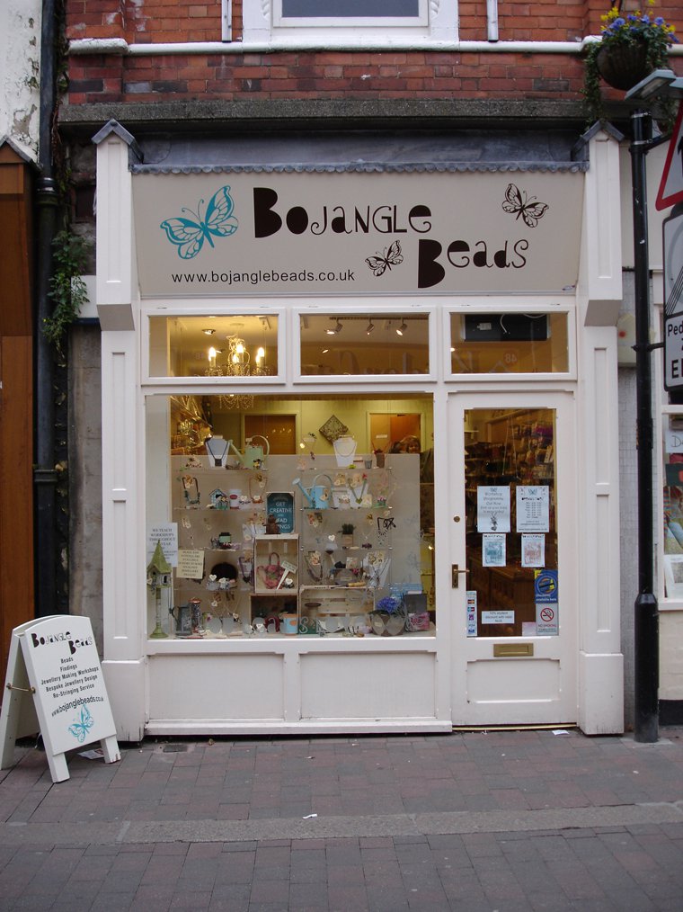 a shop front with a white frame and windows