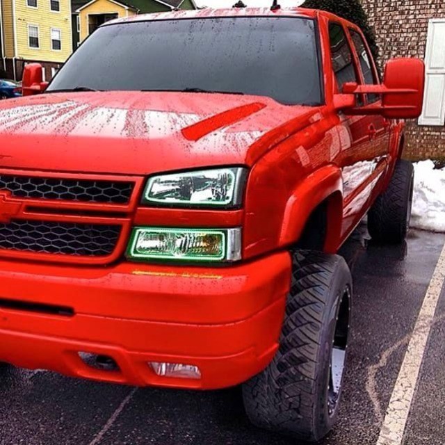a bright red truck with a black hood