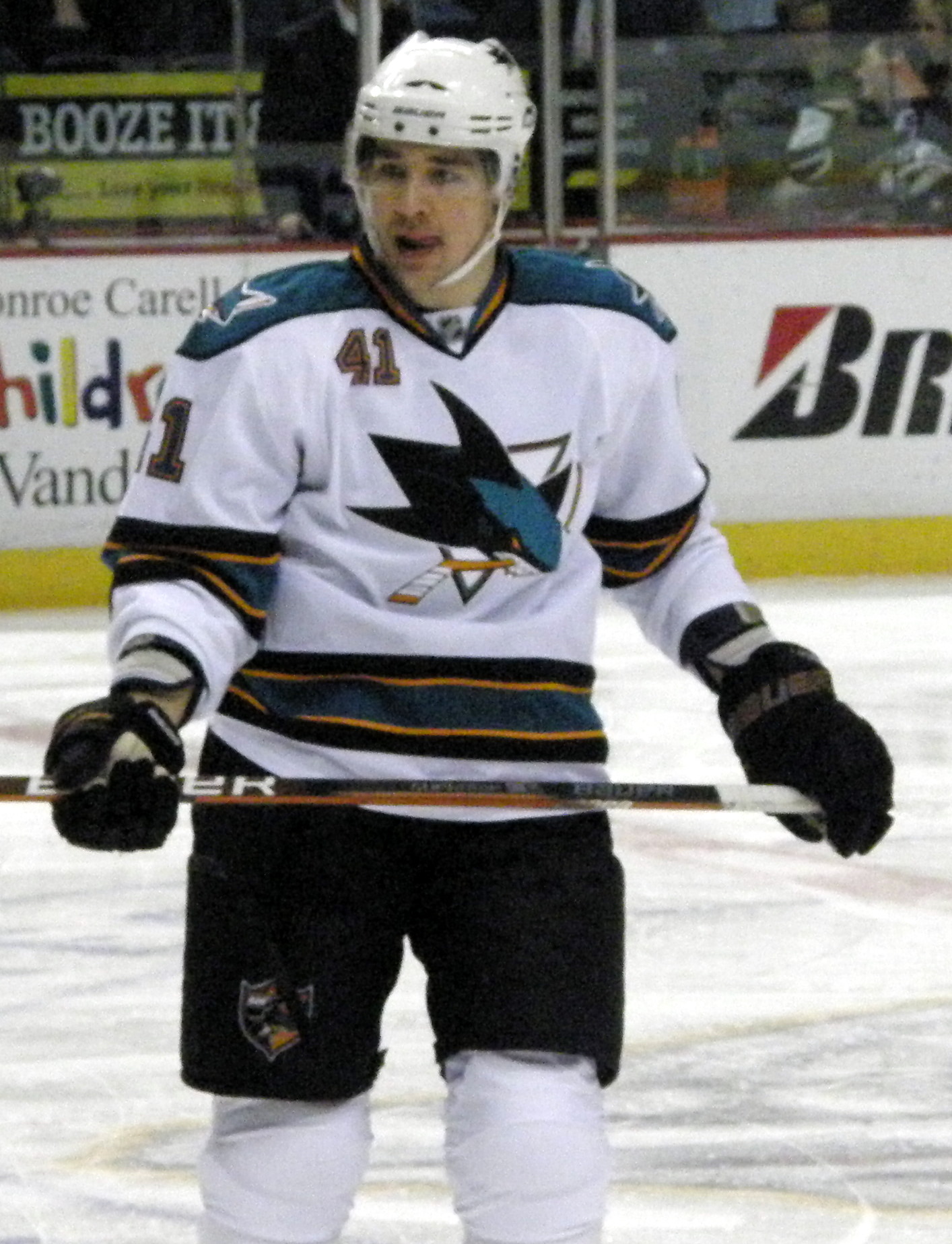 the hockey player in uniform is standing on the ice