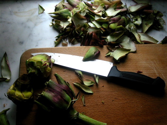 a knife laying on a  board next to flowers