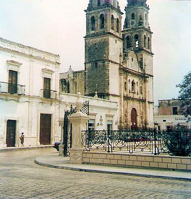 an old cathedral with a statue next to it