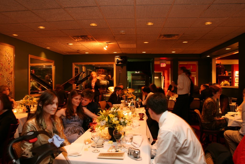 group of people sitting at a dinner table together