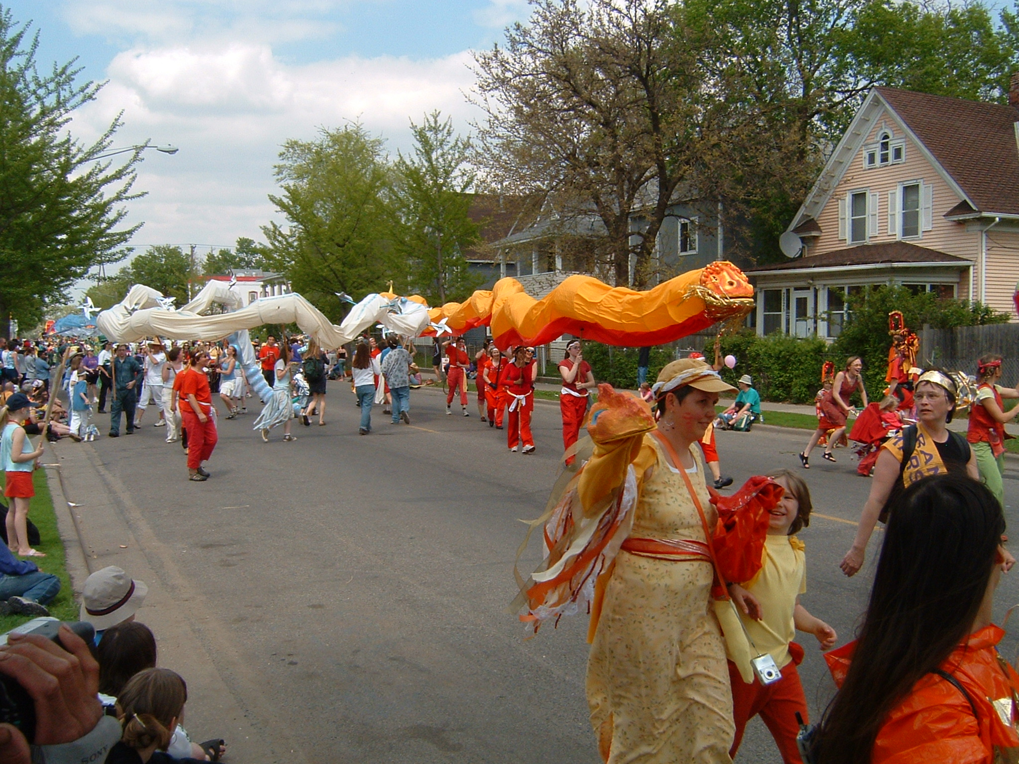 a parade on the street filled with people