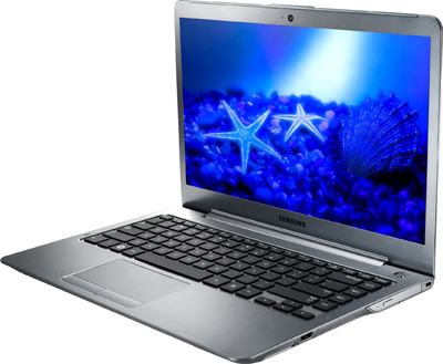 a silver laptop with blue lighting and shells