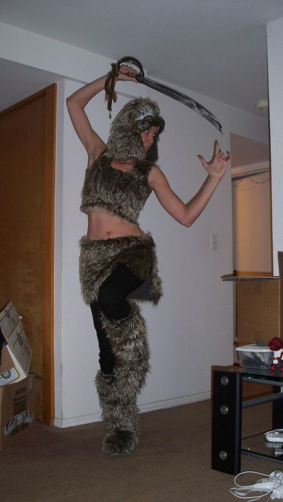 a woman in furry clothes with a sword