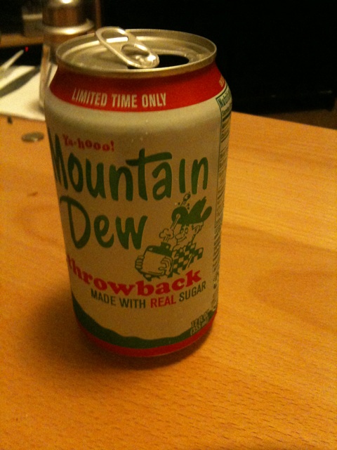 a mountain dew can on a wooden table