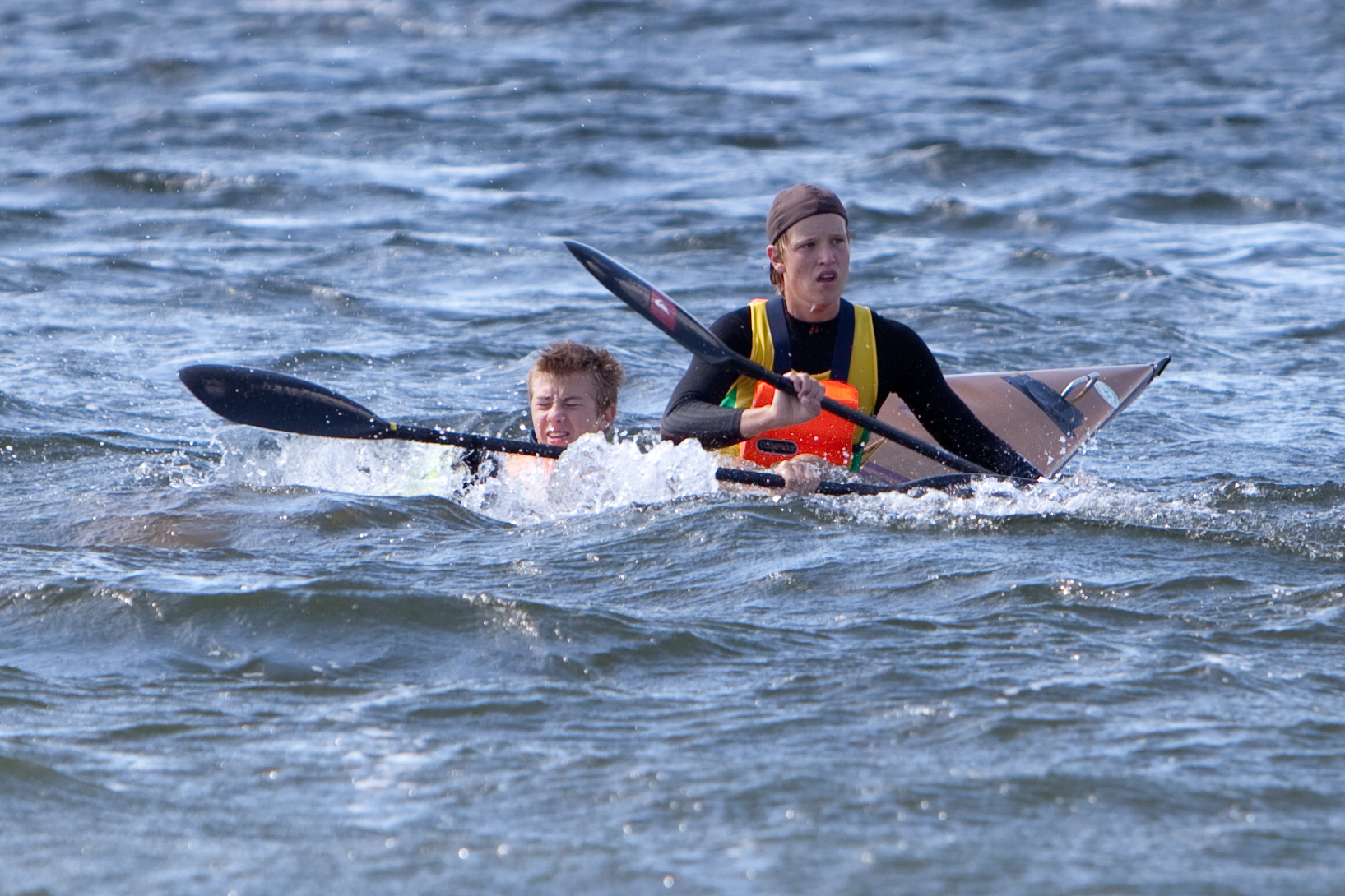 man and child kayaking in the open water