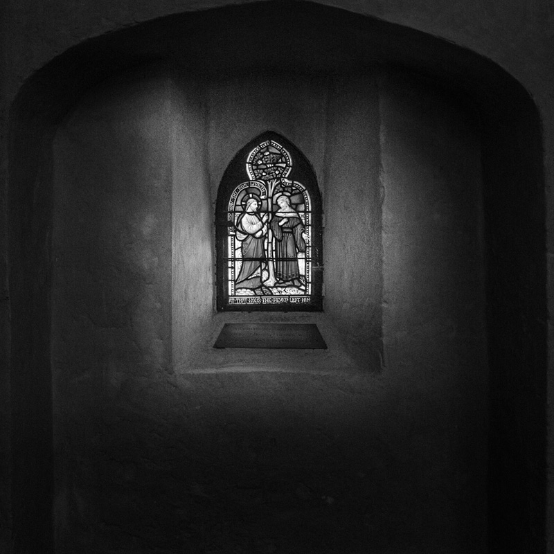 black and white pograph of a window in a small church