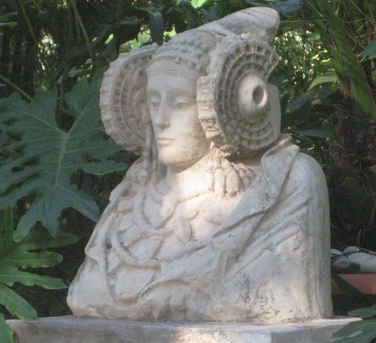 a statue of a woman with an eye patch on her hat
