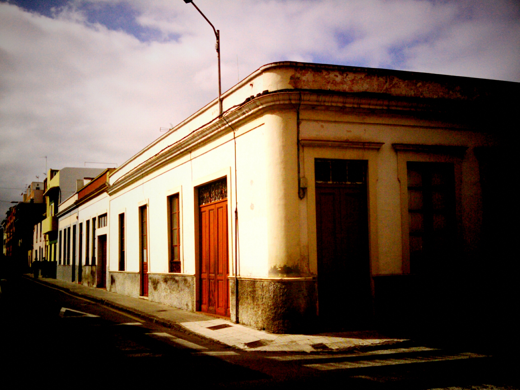 a red door is on the side of this building