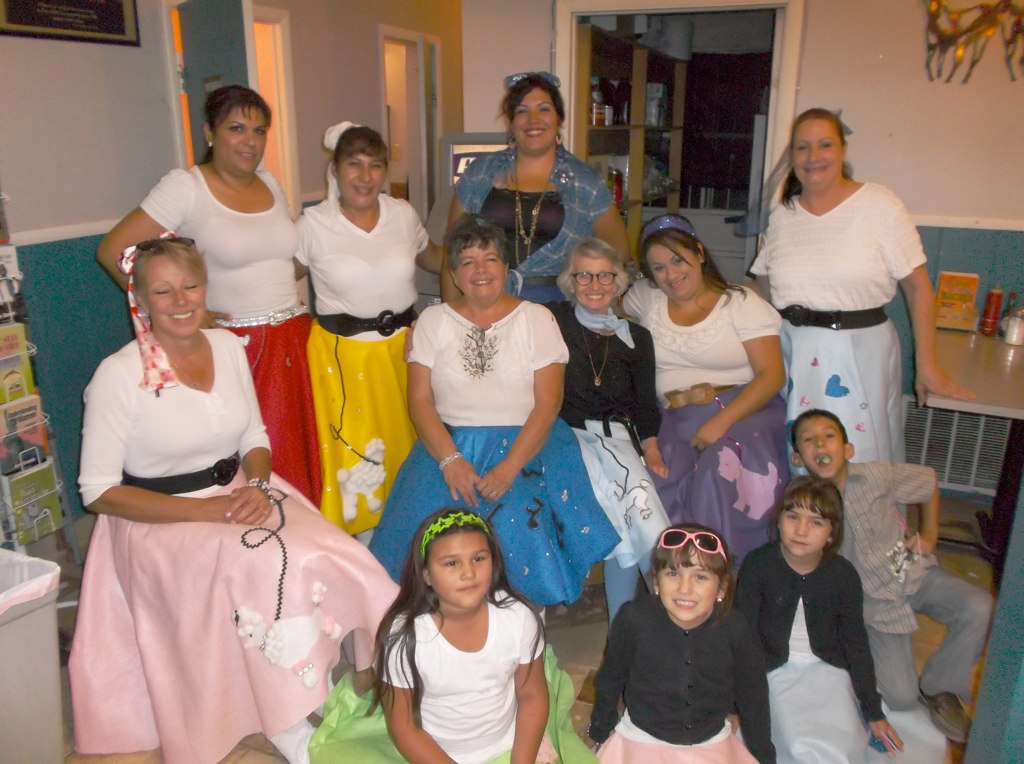 the group of woman and children pose for the camera