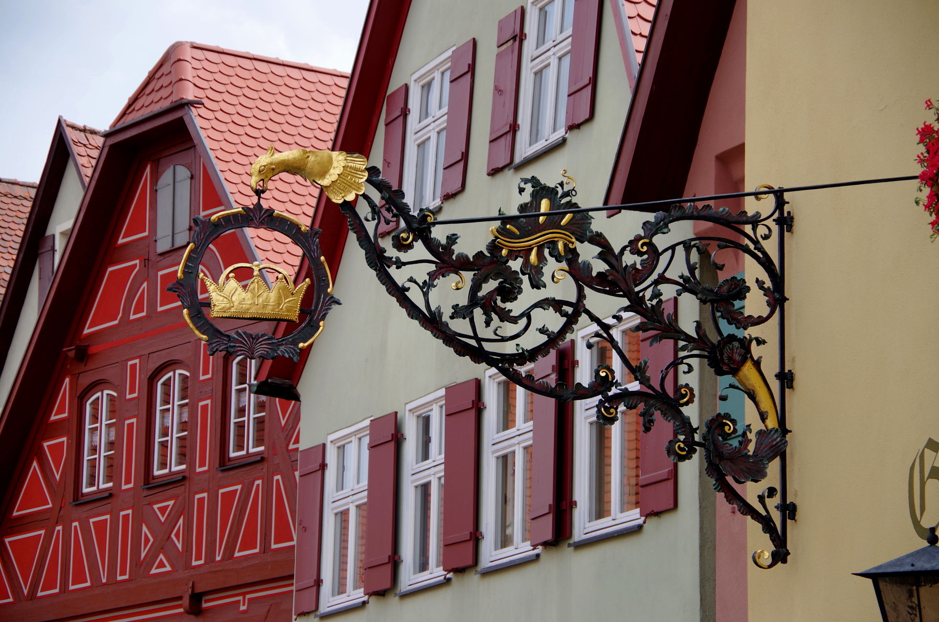 a red and white building with a clock on the side