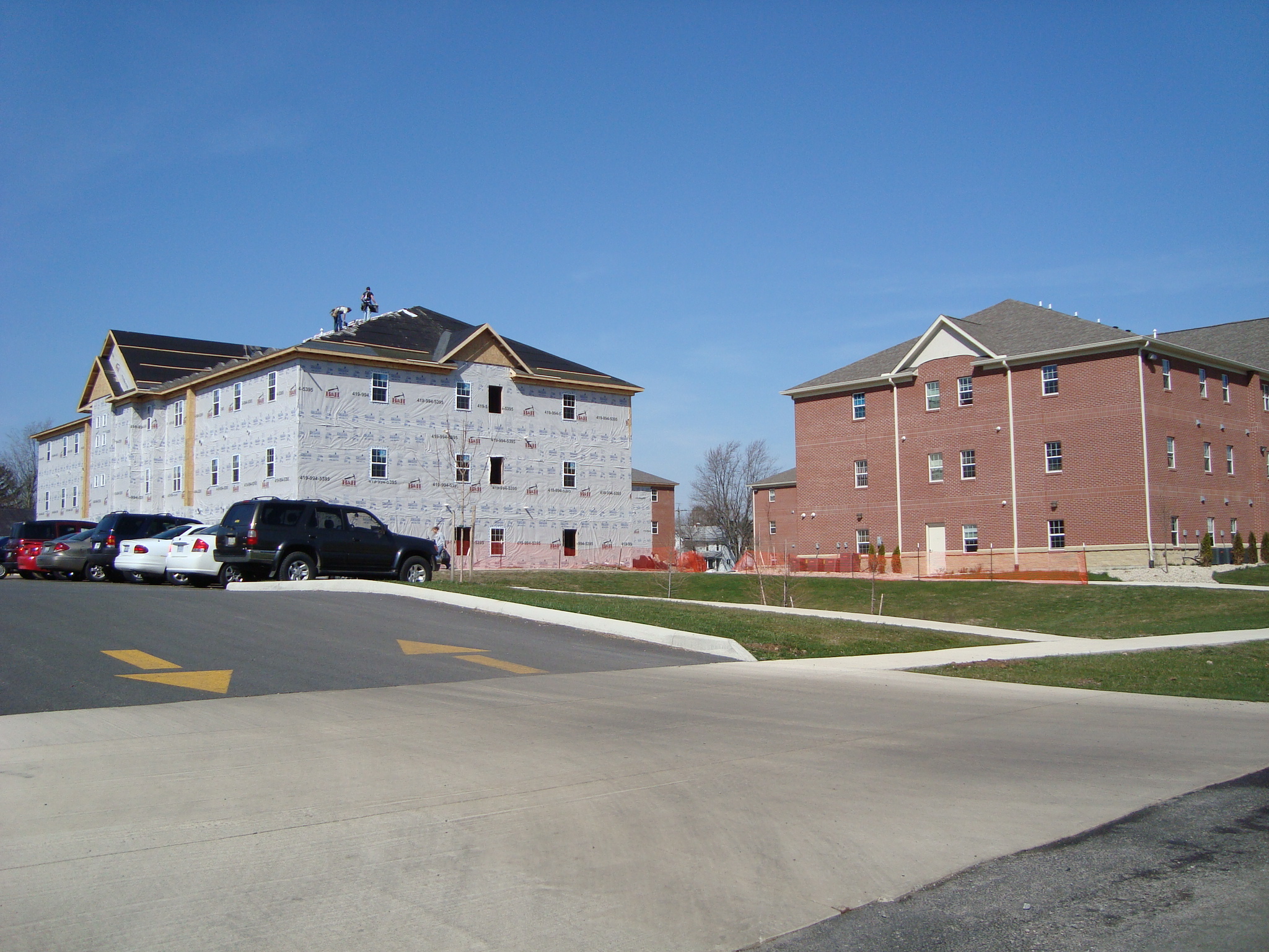 two large brick buildings next to each other in front of a street