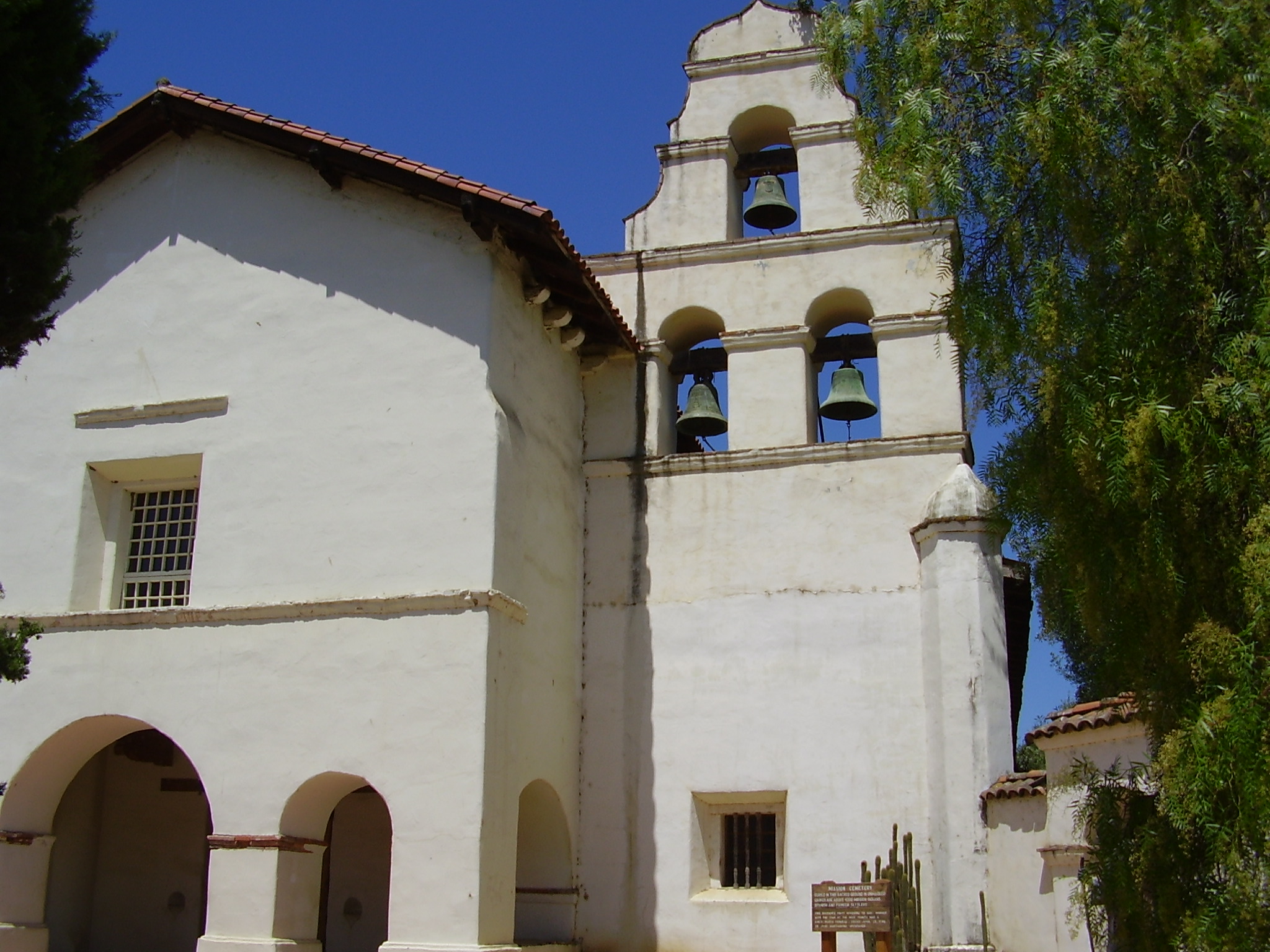 a large white building with two bells in it's windows