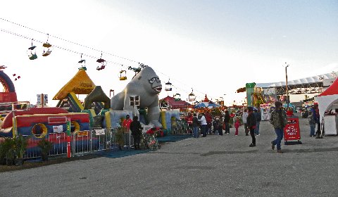 an amut area with a giant train and fair rides