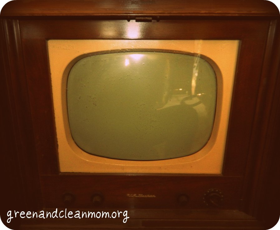 an old tv is in the dark brown wood
