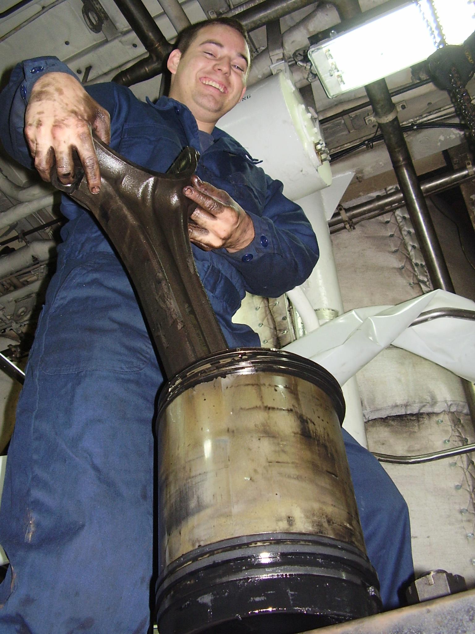 a man is holding a large steel object