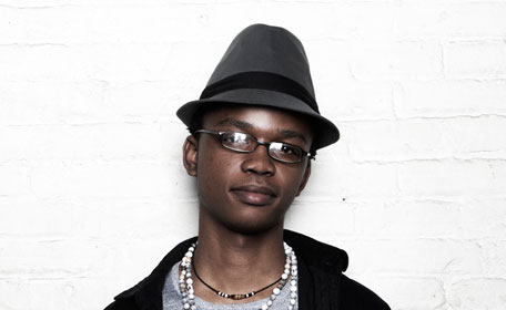 the young man is wearing a hat and glasses
